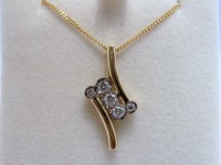 18ct yellow gold cross over pendant set with diamonds