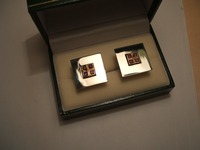 Silver cufflinks set with 4 square rubies in each