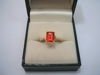 9ct yellow gold single stone ring set with octagonal cut fire opal, angular shoulders