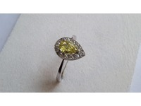 Superb platinum ring set with a centre yellow diamond , and brilliant cut diamonds around